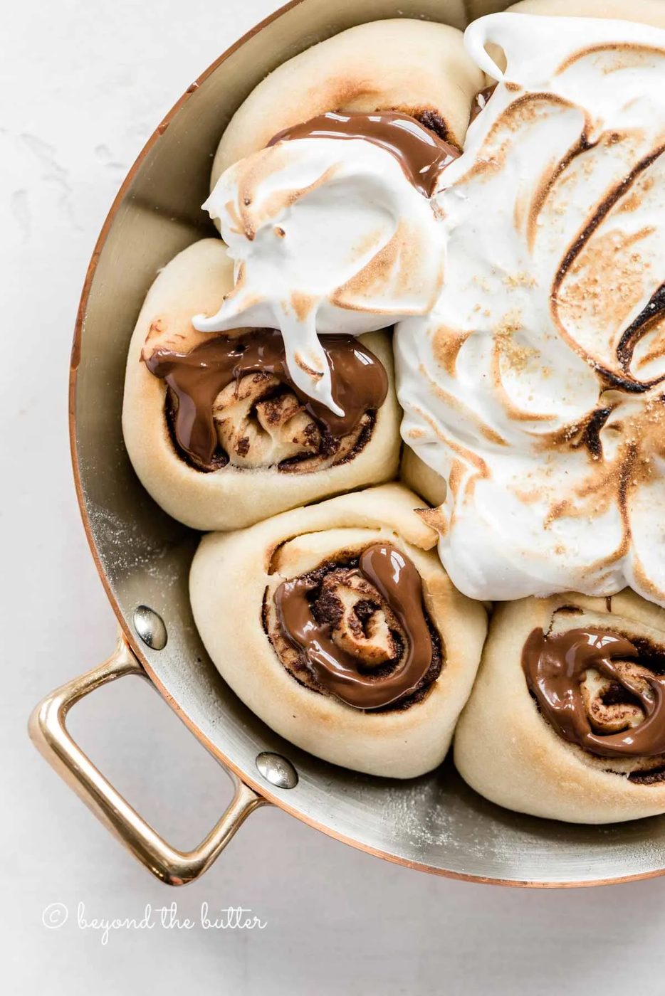 Overhead closeup image of s'mores rolls partially covered with marshmallow topping | All Images © Sovuh