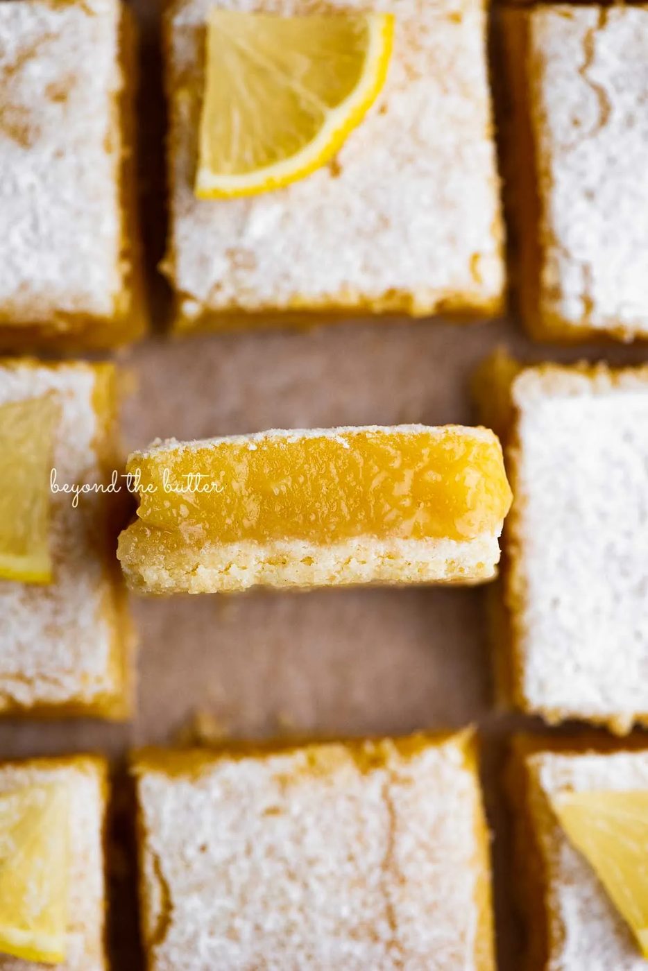 Sliced straightforward lemon bars on parchment paper | © Sovuh
