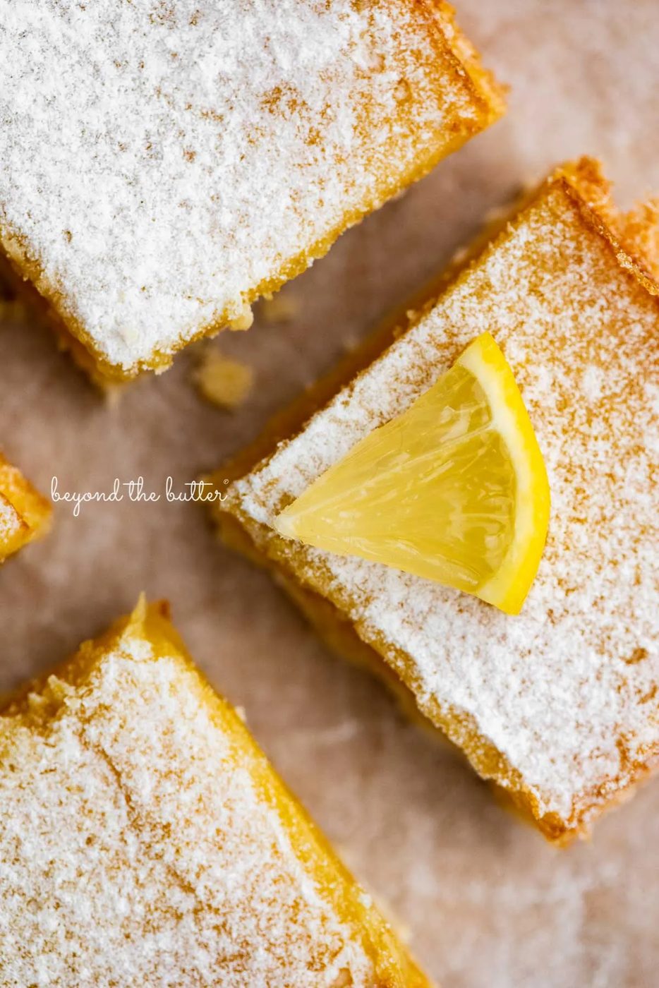 Tart and tangy lemon bars on parchment paper | © Sovuh