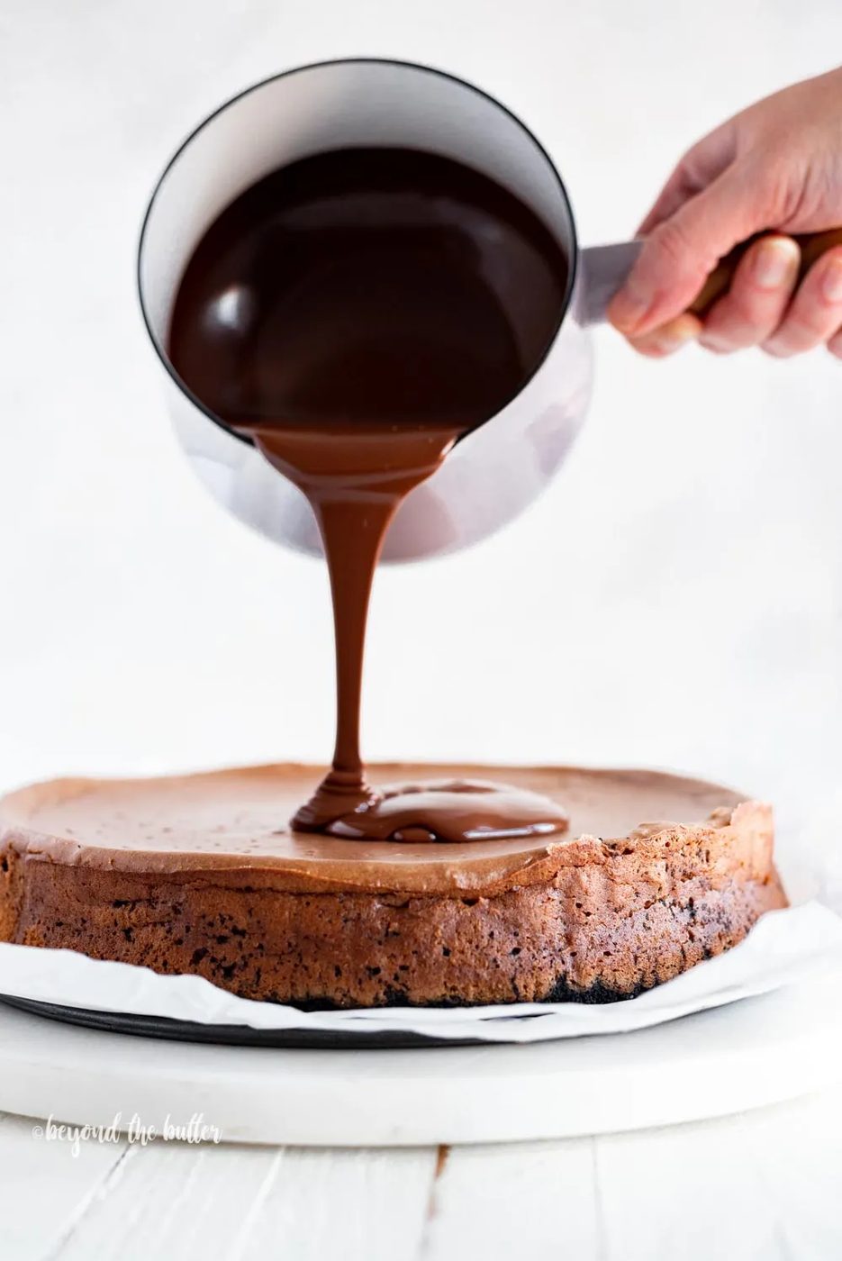 Pouring dark chocolate ganache over top of Triple Chocolate Mocha Cheesecake | All Images © Sovuh, LLC