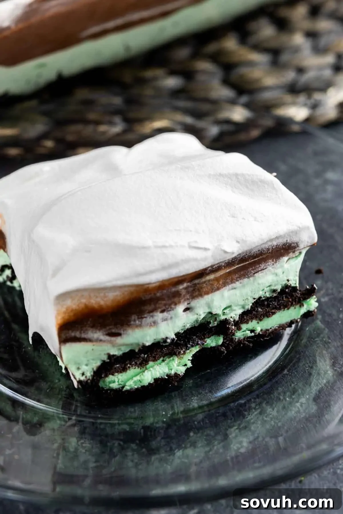 A pristine slice of Mint Oreo Dessert on a white plate, showcasing its perfect layers and inviting texture.
