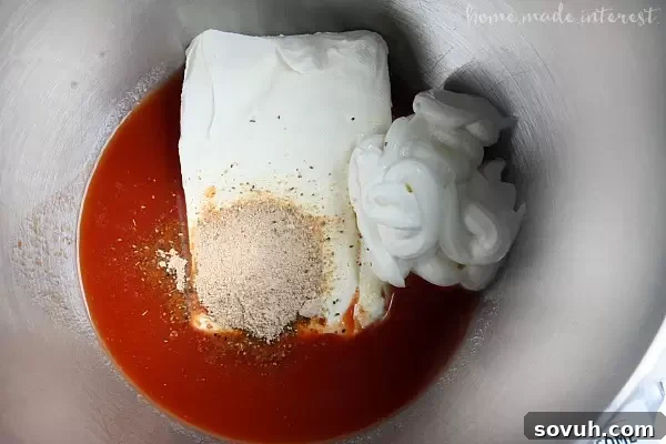 Close-up step-by-step imagery showing the mixing process of ingredients for the creamy Bloody Mary Crab Dip, highlighting its smooth texture and ease of preparation.