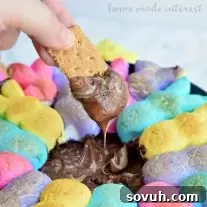 This easy Easter dessert recipe is made with two kinds of chocolate and bunny rabbit peeps, toasted up into an ooey gooey s’mores dip.