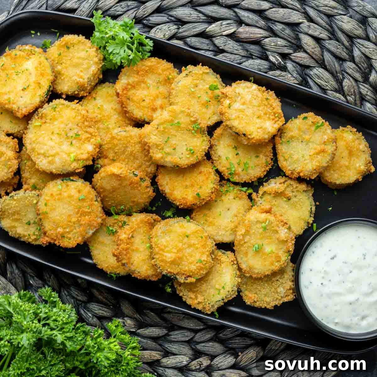 Crispy Zucchini Fritte on a black platter, served as an appetizer.