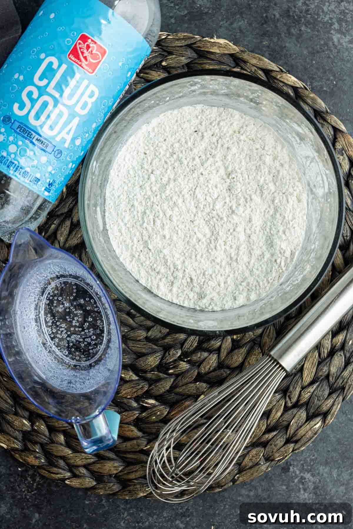 Zucchini Fritte batter ingredients being mixed with soda water.