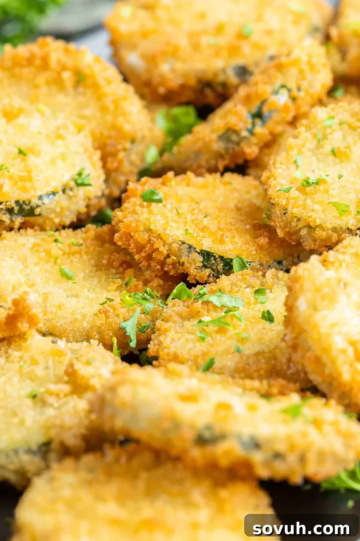 Close-up of breaded zucchini slices before frying, showing the panko coating.
