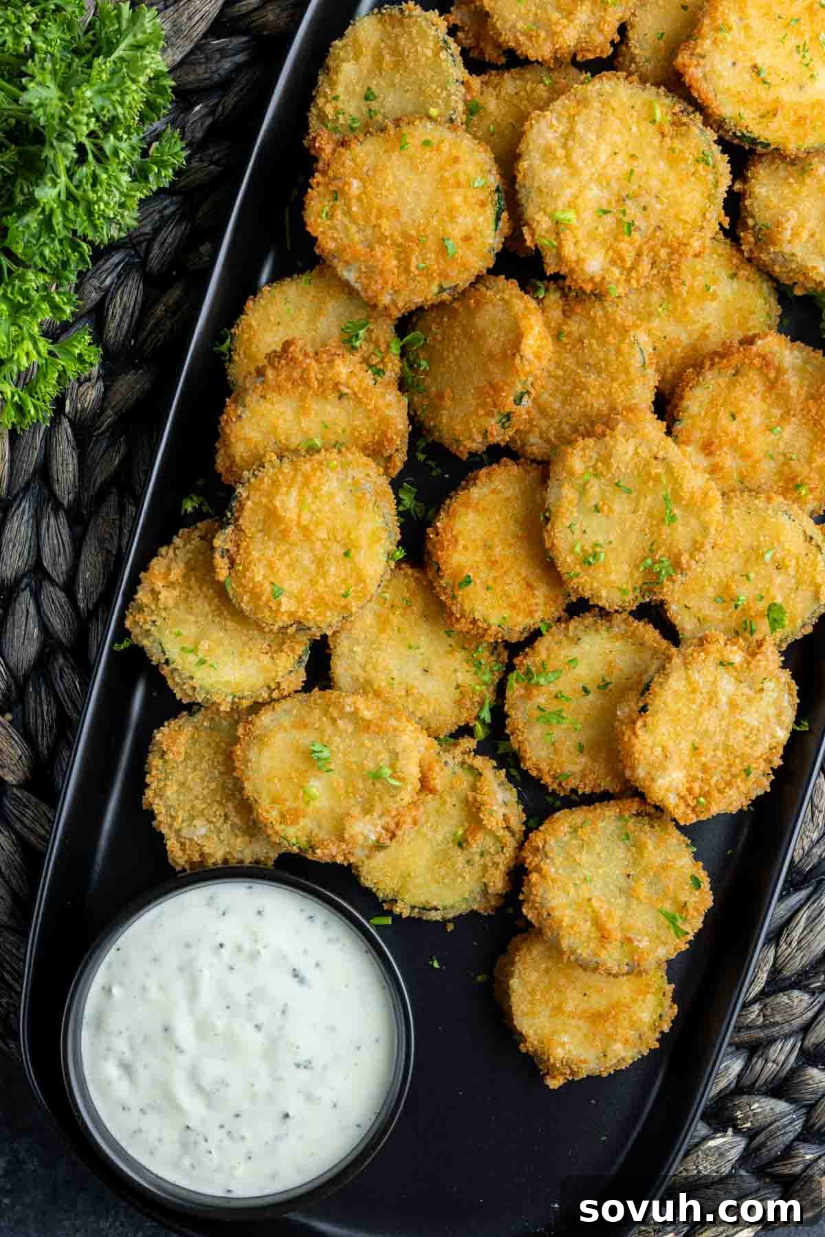 A platter of crispy Zucchini Fritte served with a small bowl of lemon aioli for dipping.