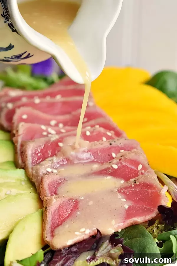 This light and fresh seared tuna salad is a healthy lunch option mixed with mangoes and avocados and topped with a Miso vinaigrette.