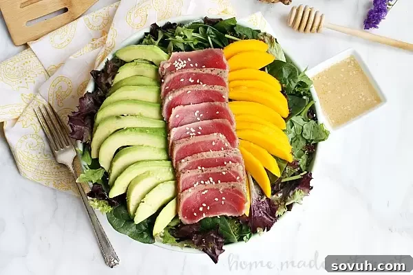 This light and fresh seared tuna salad is a healthy lunch option mixed with mangoes and avocados and topped with a Miso vinaigrette.