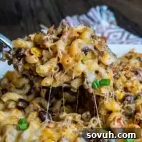 spoon if Taco Mac and Cheese Casserole with beans