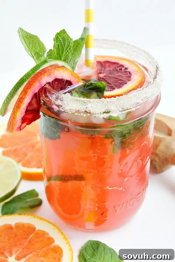 Blood Orange Mojito from the side garnished with oranges