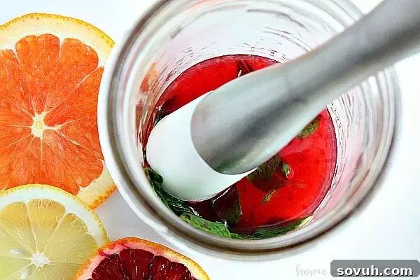 Blood Orange Mojito being made with a muddler