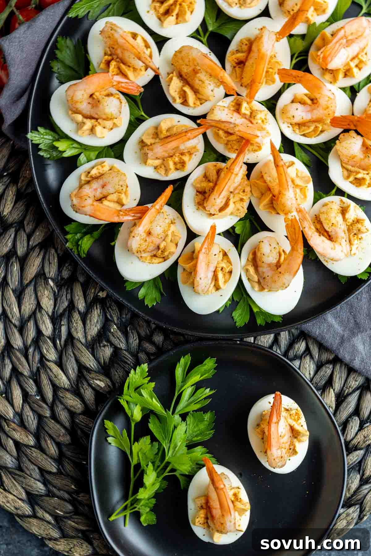 A beautifully arranged platter of Shrimp Cocktail Deviled Eggs, garnished with fresh dill and a sprinkle of Old Bay seasoning, ready to be served.
