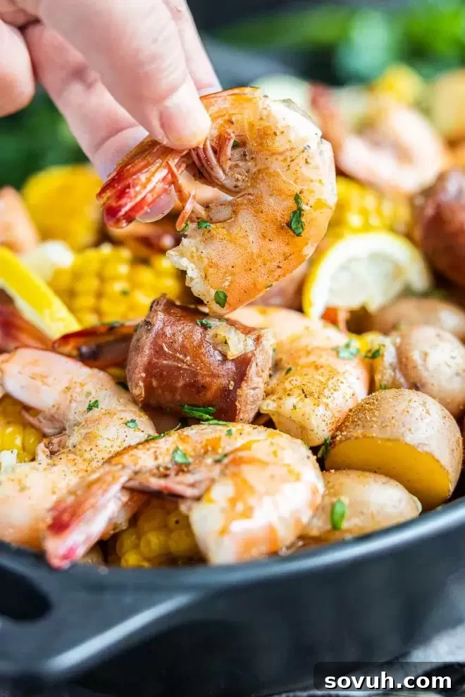 holding a shrimp from ingredients for a Instant Pot Shrimp Boil