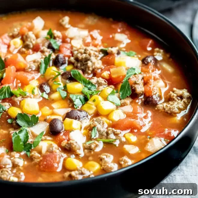 a black bowl filled with taco soup slow cooker