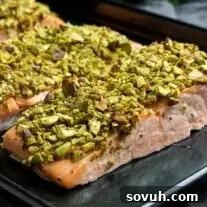 Pistachio crusted salmon on black sheet pan