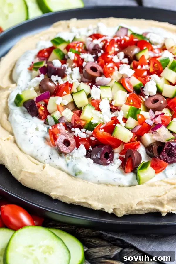 5 Layer Greek Dip garnished with briny Kalamata olives