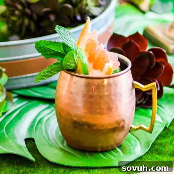 Refreshing Citrus Moscow Mule cocktail served in a copper mug with fresh fruit garnish