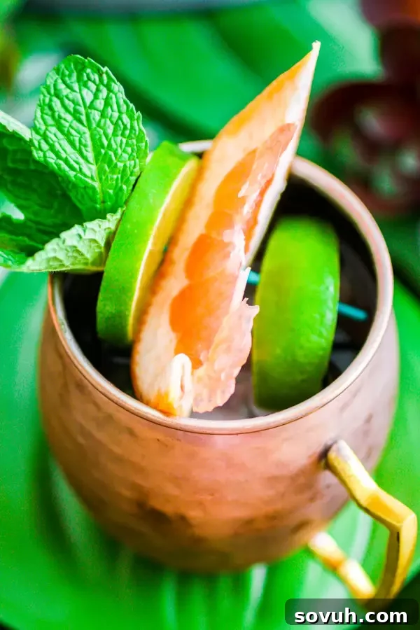 Citrus Moscow Mule in a copper mug with lime and grapefruit garnishes, perfect for brunch
