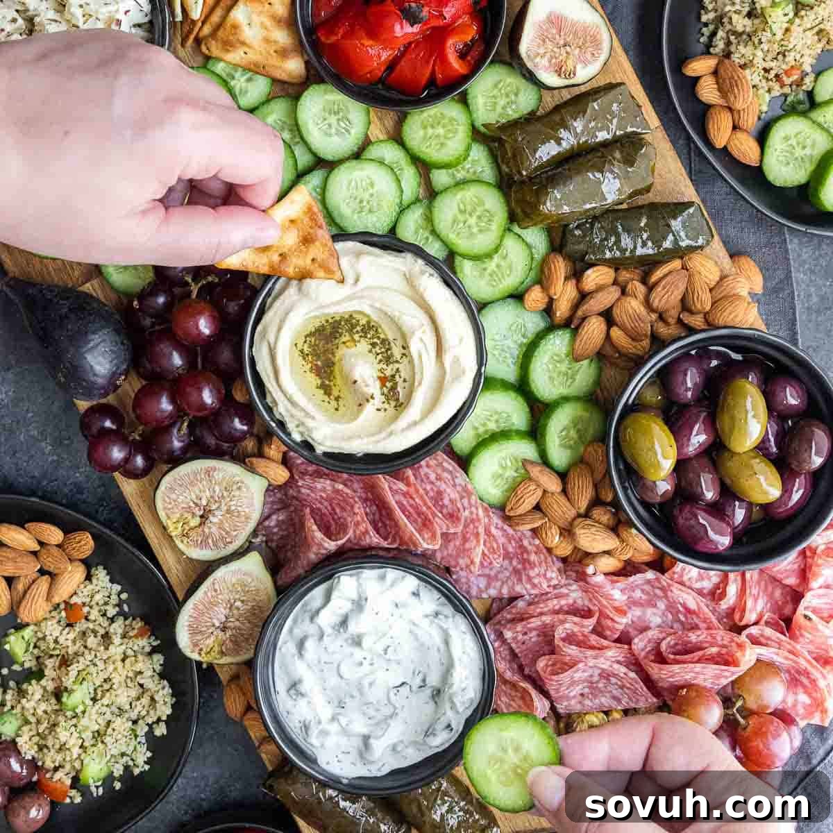 Dipping in hummus and other delicious dips from a vibrant Mediterranean Mezze Platter