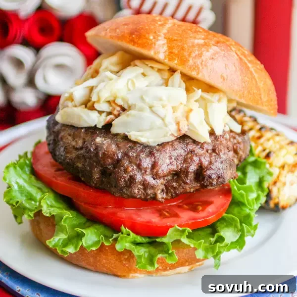 Chesapeake Crab burger on a bun with lettuce and tomato, showcasing a gourmet summer dish.