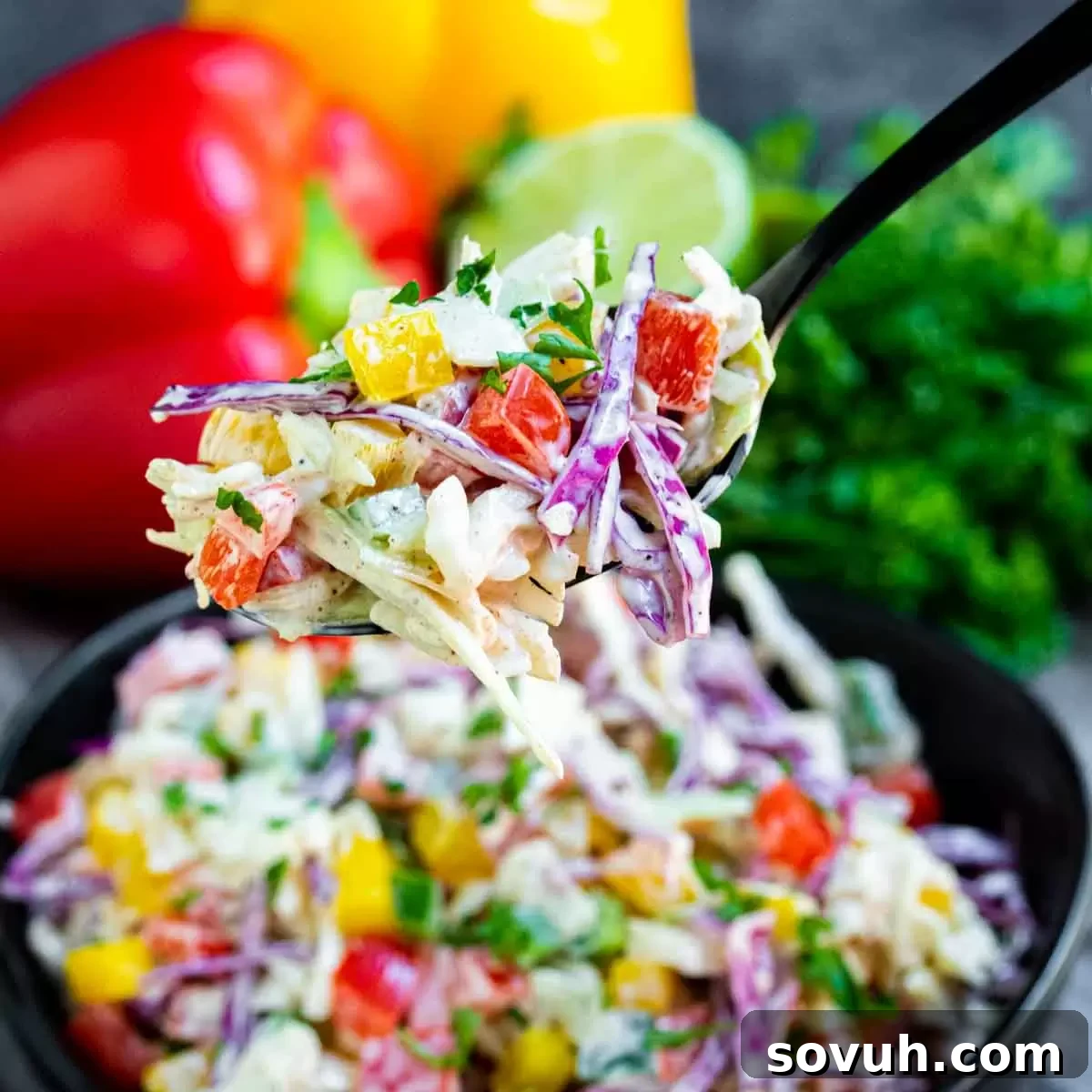 Spicy Jalapeno Coleslaw on a fork, showcasing its vibrant colors and creamy texture, a perfect picnic side dish or BBQ accompaniment.