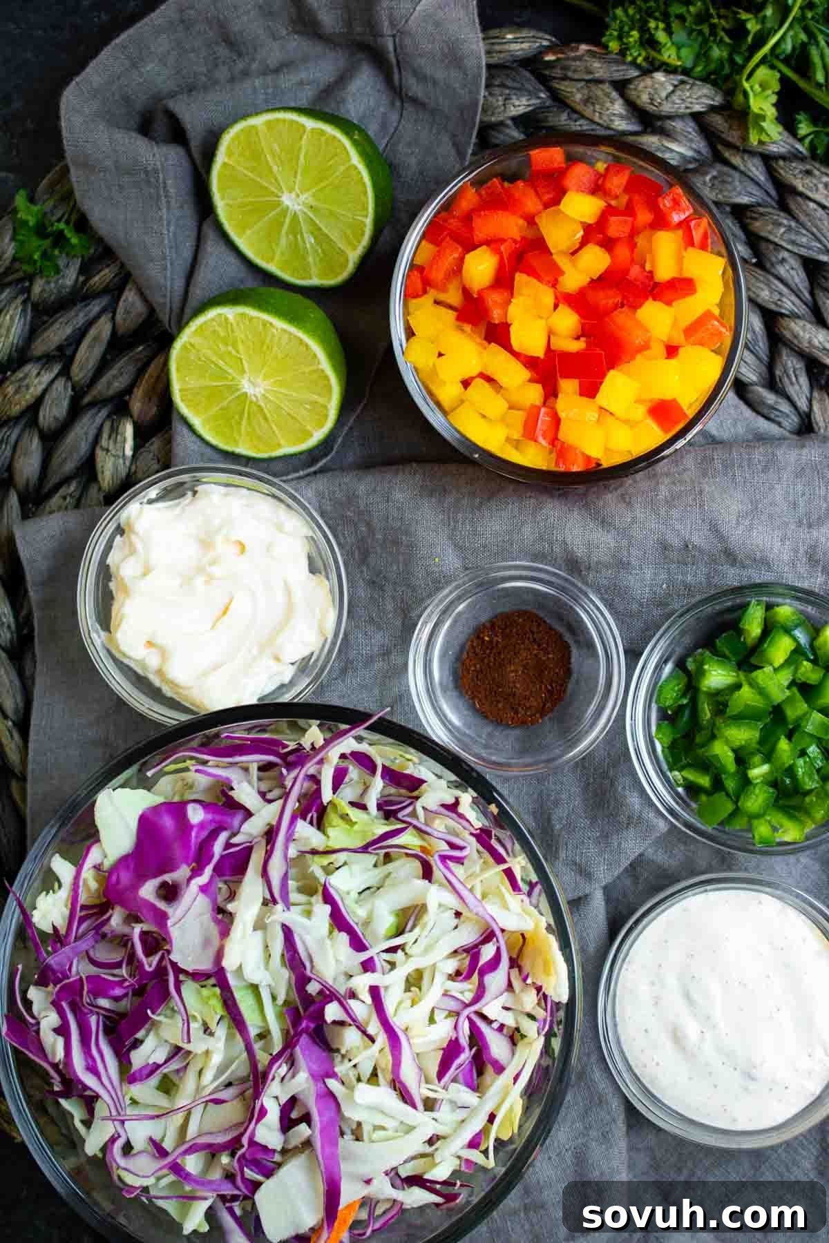 A vibrant display of fresh ingredients for Spicy Jalapeno Coleslaw, including colorful bell peppers, crisp cabbage, and a whole jalapeno, ready to be prepared.