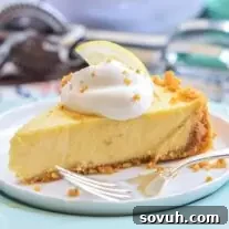 Lemon Icebox Pie slice on a plate with fork laying on it