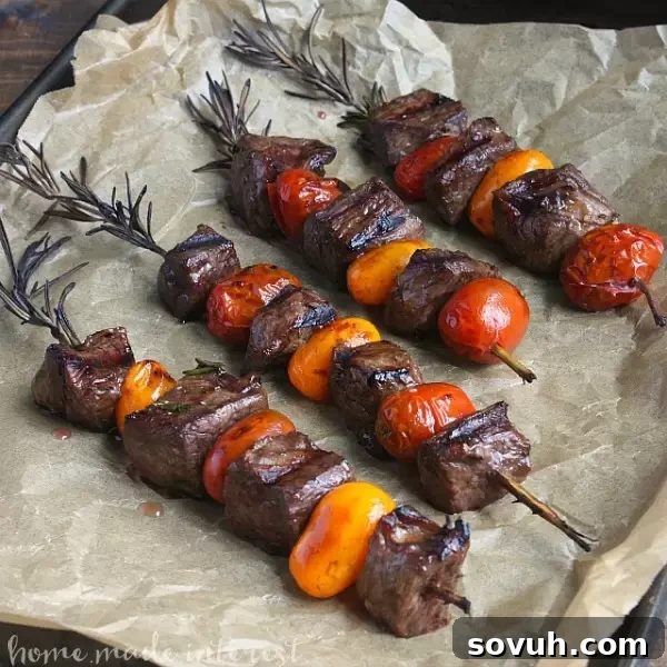 Plated Balsamic Glazed Rosemary Steak Skewers ready to serve, garnished with fresh rosemary sprigs, highlighting their appetizing appeal as a gourmet yet simple summer meal.