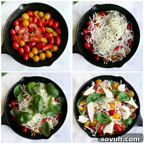 Close-up of the assembled ingredients for Baked Caprese Dip in a skillet, showcasing grape tomatoes, shredded mozzarella, fresh basil, and cubed fresh mozzarella.