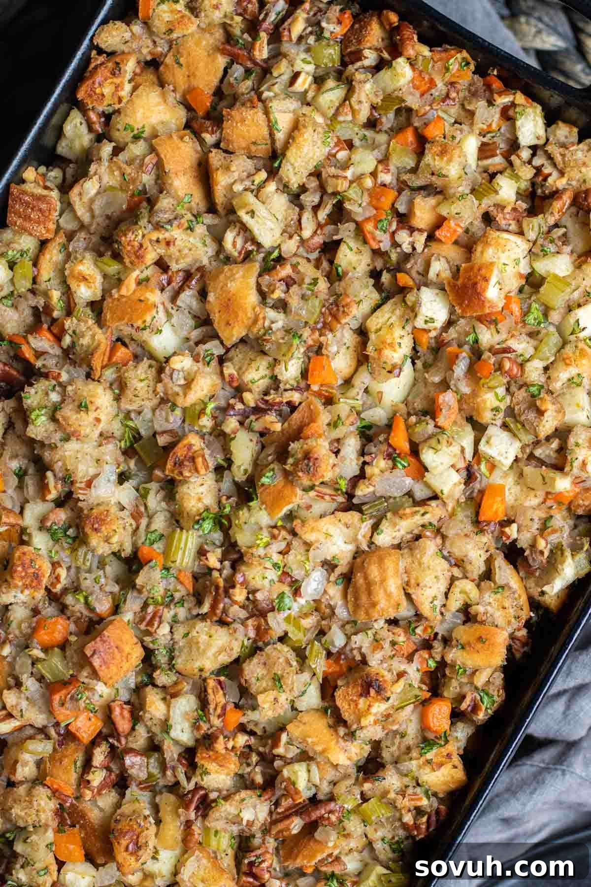 black casserole dish with pecan apple stuffing