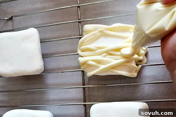 Phantom Puffs 4 Step-by-step image showing the process of piping almond bark onto marshmallows for the mummy effect.
