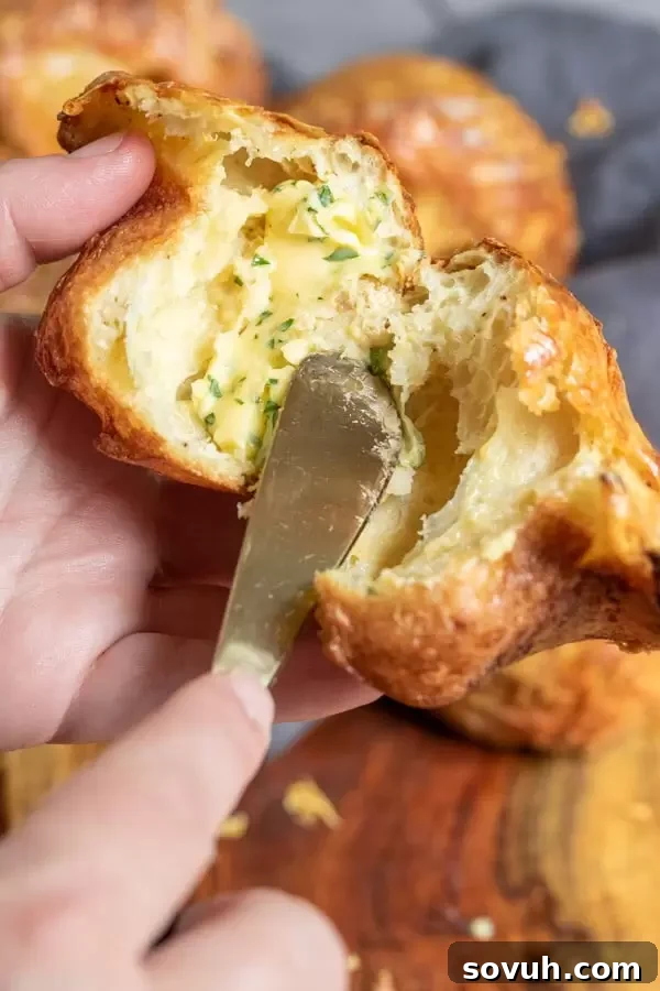 Easy holiday Gruyere Popovers presented beautifully in a bread basket, ready for serving at a festive meal.