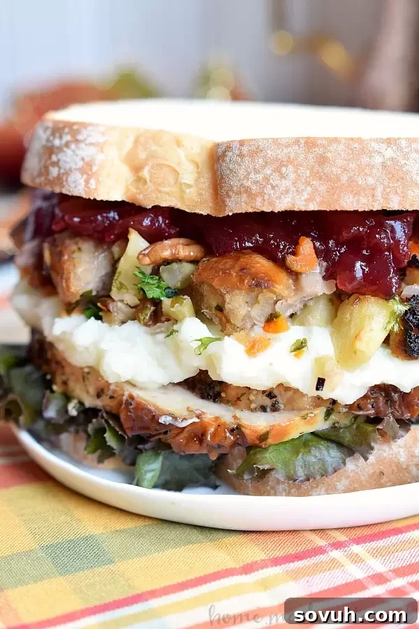 Indulge in the ultimate post-Thanksgiving delight with this incredible sandwich, featuring layers of all your favorite holiday leftovers – turkey, mashed potatoes, stuffing, and cranberry sauce – a perfect blend of sweet and savory.