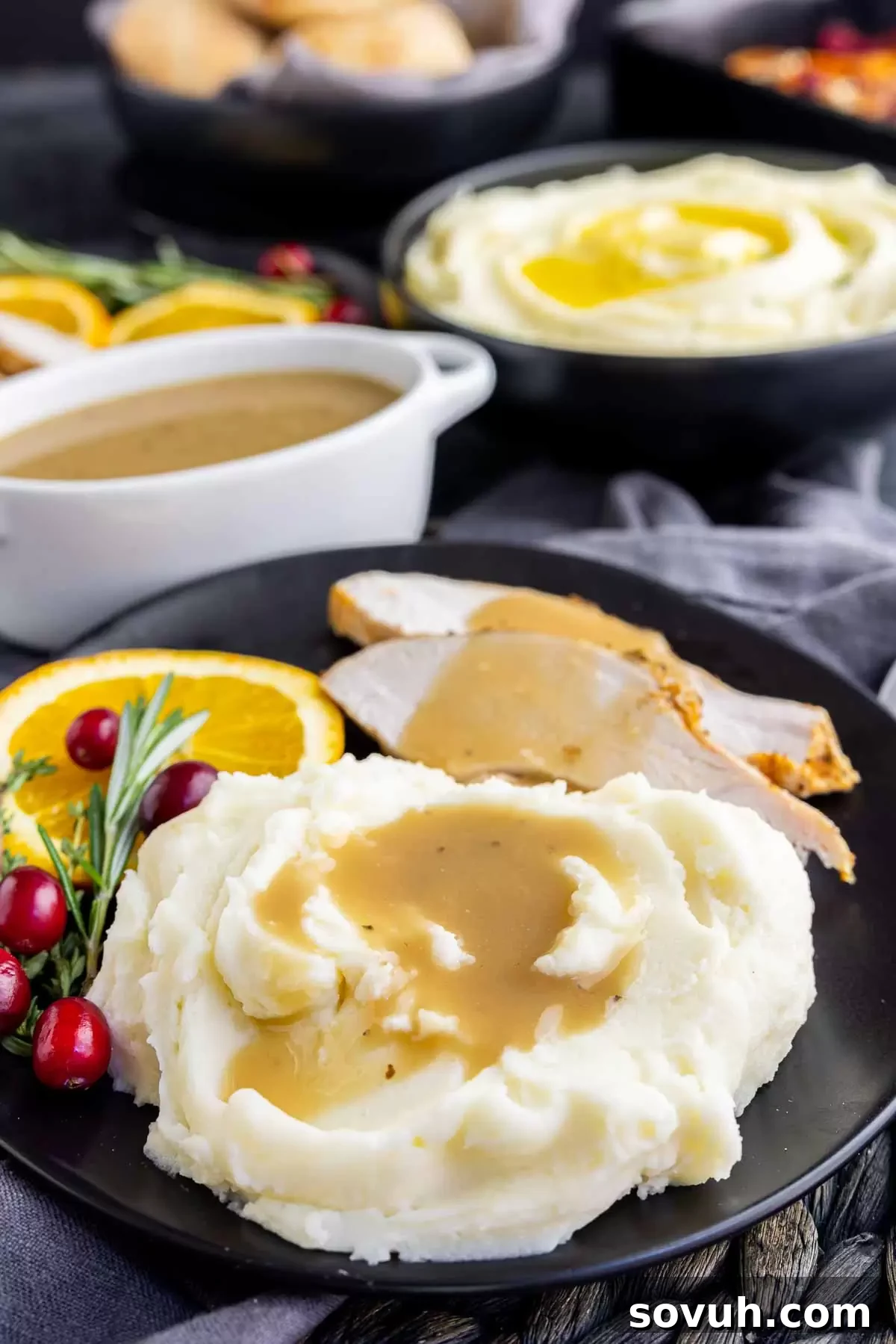 A plate of turkey with gravy and a generous serving of Not Your Mom's Mashed Potatoes.