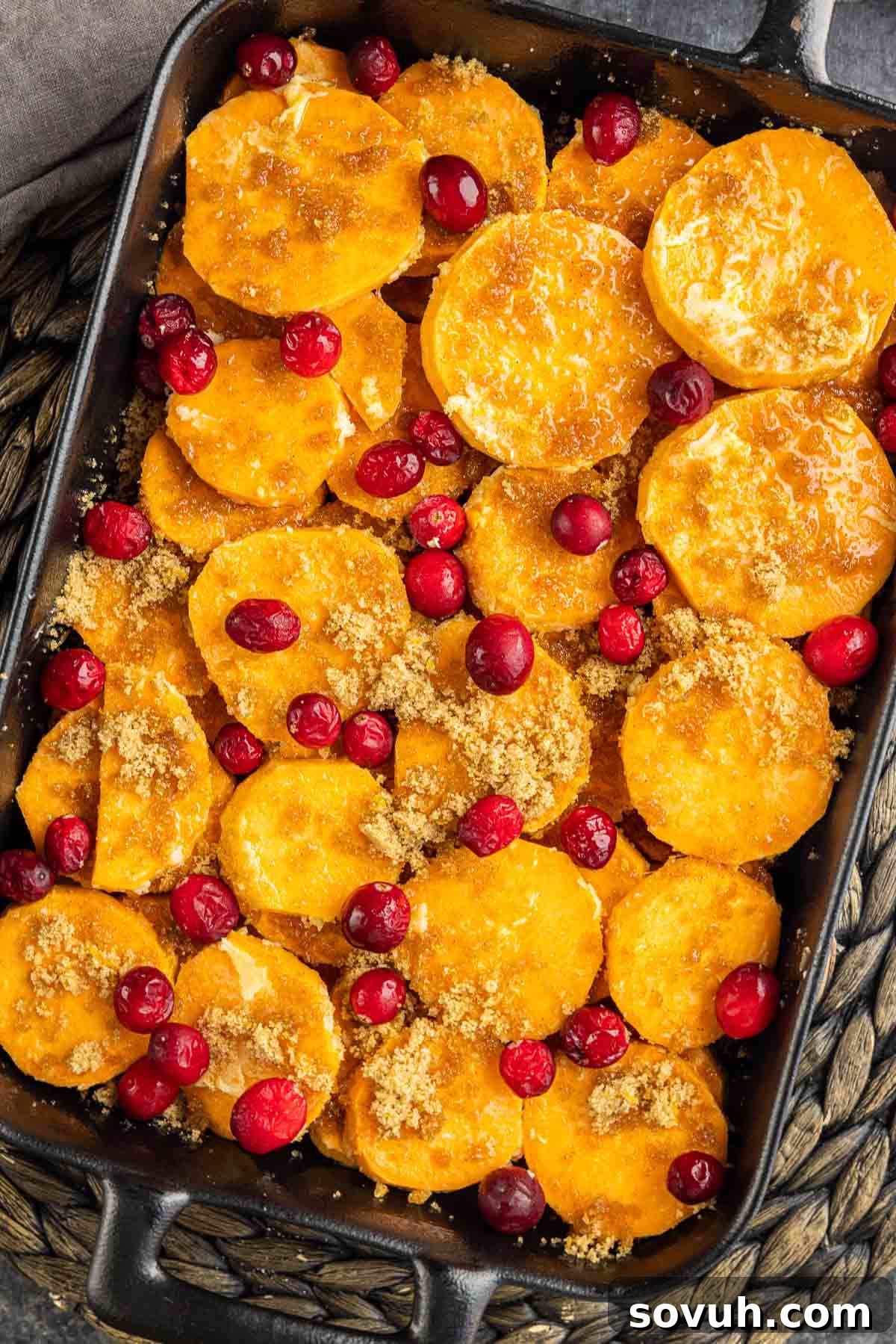 Step-by-step images showing how to prepare Cranberry Sweet Potato Casserole, including layering the potatoes and adding cranberries.