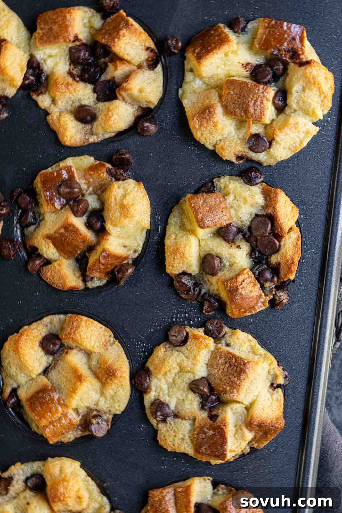 Mini bread puddings with chocolate chips baked in a muffin pan.