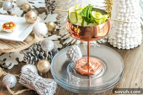 A festive Champagne Moscow Mule cocktail in a copper mug with lime, perfect for holiday parties