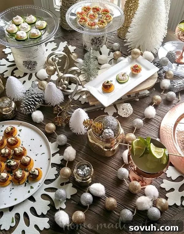 An elegant holiday tablescape with Mini Crab Cake Bites and other appetizers, featuring gold, silver, and copper decor