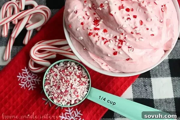 This easy no bake peppermint fluff dip is an easy dessert recipe that even the kids can make! Crush peppermints and creamy marshmallow fluff make this dip perfect for Christmas dessert! If you like marshmallow fluff and cream cheese together you are going to love this peppermint dessert.