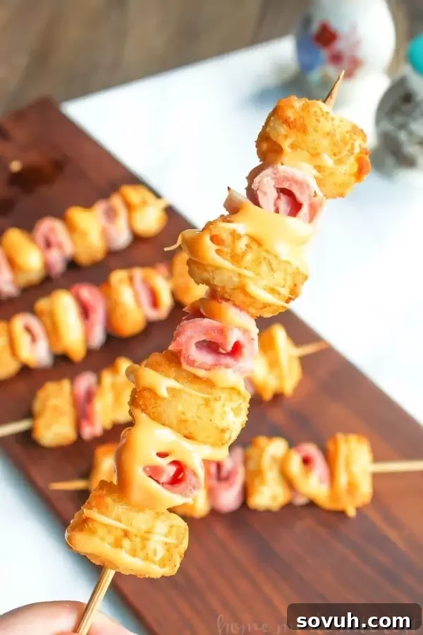 Ham and Cheese Tater Tot Skewers | If you are looking for a simple but totally awesome Game Day appetizer this game day recipe is it. Ham and Cheese Tater Tot Skewers are an easy appetizer recipe with layers of ham and tater tots skewered together and drizzled with creamy american cheese. This is going to be perfect food for your next super bowl party or football party!