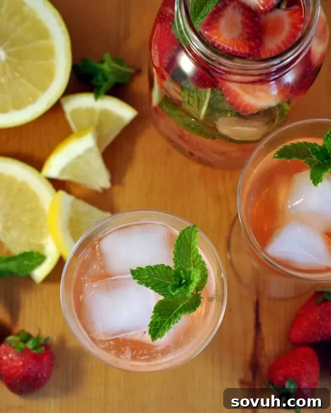 top down picture of glasses filled with strawberry grapefruit water and mint