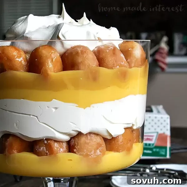 Donut Trifle | This decadent dessert recipe uses Krispy Kreme doughnuts to make an easy trifle recipe. Layers of whipped cream, vanilla pudding and donut holes makes an easy donut trifle recipe that everyone is going to love. Trifle is an easy dessert recipe for the holidays and it would make a great potluck dessert recipe for summer picnics.