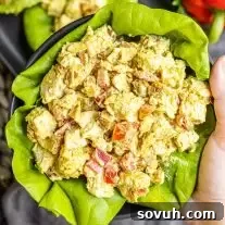 holding a bowl of Curry Chicken Salad