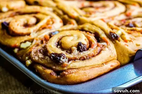 Perfectly baked Carrot Cake Cinnamon Rolls, generously topped with a rich cream cheese frosting.