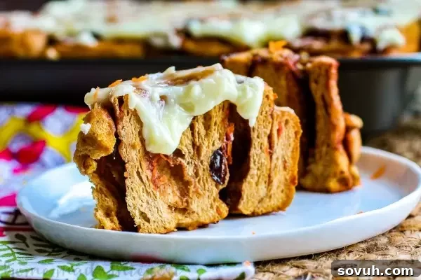 A vibrant display of Carrot Cake Cinnamon Rolls, showcasing the rich filling and creamy frosting.
