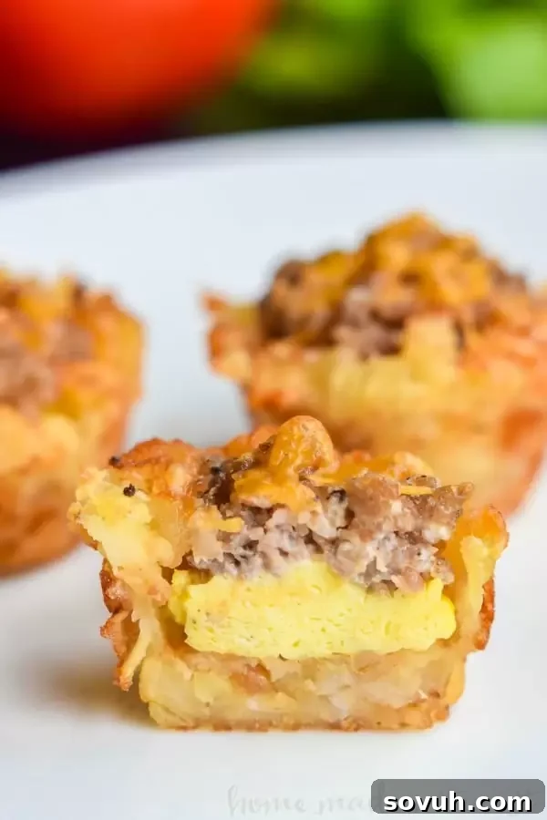 Sausage Egg and Cheese Breakfast Tots in a mini muffin tin, showcasing the process of filling them with scrambled eggs and sausage.