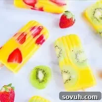 All Natural Mango Popsicles | Fruit popsicles are a great way to get your kids to eat more fruits and to stay hydrated in the summer. These all natural mango popsicles are mixed with kiwi and strawberry pieces for delicious no sugar added fruit popsicles. These beautiful mango kiwi popsicles and mango strawberry popsicles are going to be an awesome summer popsicle recipe for kids and adults!