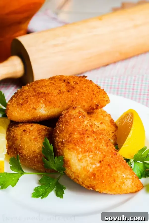 A vertical shot of the delicious Portuguese Shrimp Turnovers (Rissóis de Camarão), perfect for make-ahead party appetizers and seafood enthusiasts. A classic Portuguese recipe.