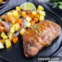 Sheet Pan Spicy BBQ Pork Chops and Potatoes on a black plate